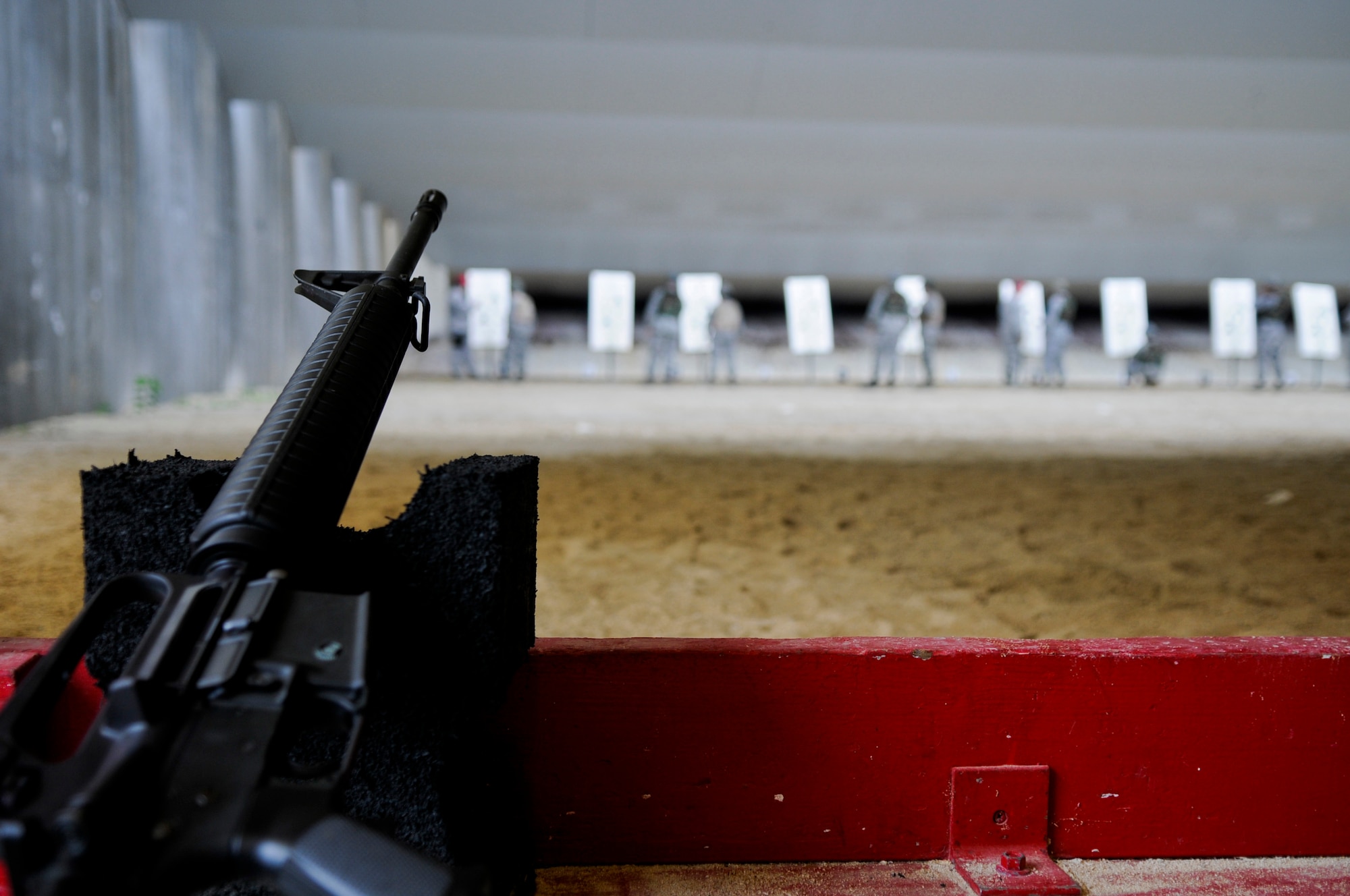 Airmen qualifying at the 18th Security Forces Squadron's newly-refurbished Combat Arms firing range wait for a CA instructor to mark sight corrections on their zeroing targets May 24. CA has recently received renovations on the formerly condemned building and classroom and the uncontained firing range to make it safer for qualifying Airmen. Currently, about 75 percent of all renovations to the section are complete and is projection to be finished in the next three months. (U.S. Air Force photo/ Airman 1st Class Maeson L. Elleman)