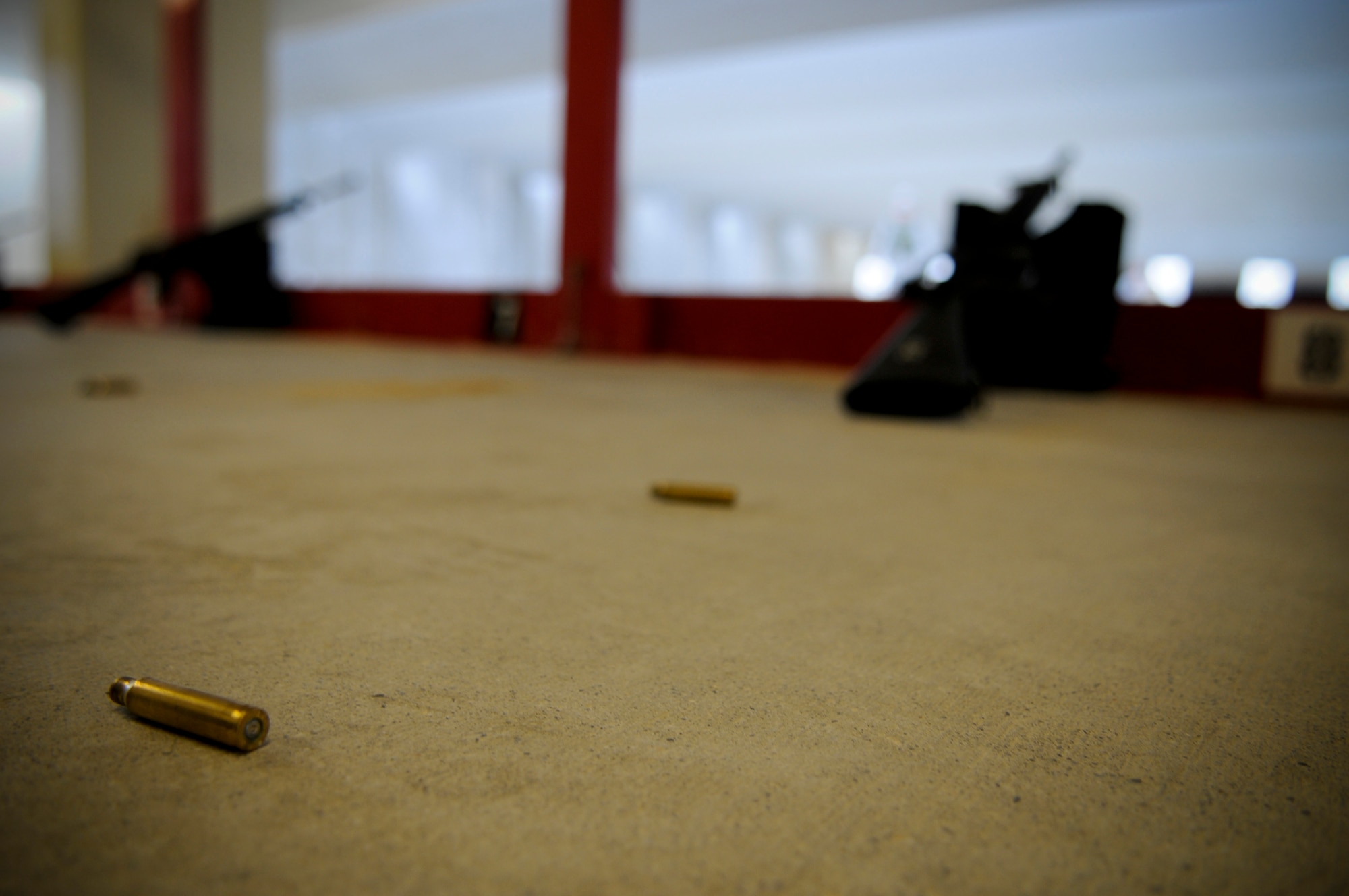 Weapons await the qualifying round for soon-to-deploy Airmen at the 18th Security Forces Squadron's recently-renovated Combat Arms firing range May 24. After a series of lengthy renovations to Kadena's old range, Airmen will no longer have to transfer from the security forces building's classroom on Kadena to the Marine Corps range on Camp Hansen, saving Kadena money in transportation costs, vehicle maintenance and man-hours. (U.S. Air Force photo/ Airman 1st Class Maeson L. Elleman)