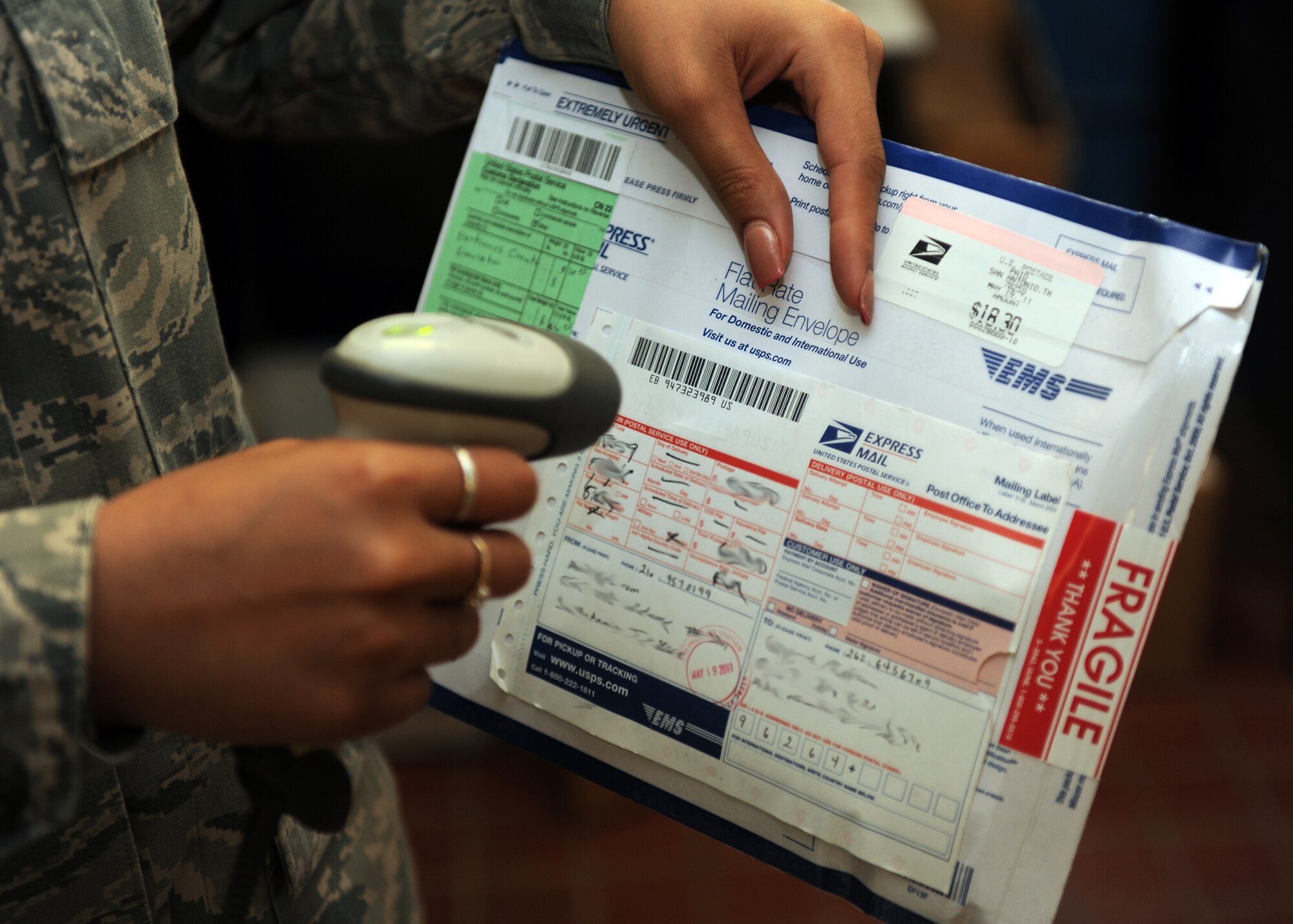 KUNSAN AIR BASE, Republic of Korea -- Staff Sgt. Whitney Ward, 8th Communications Squadron finance clerk for postal operations, scans a package after reception here May 24. Packages are scanned to confirm receipt on base. The post office is responsible for all incoming and outgoing mail on base. (U.S. Air Force photo/Senior Airman Ciara Wymbs)
