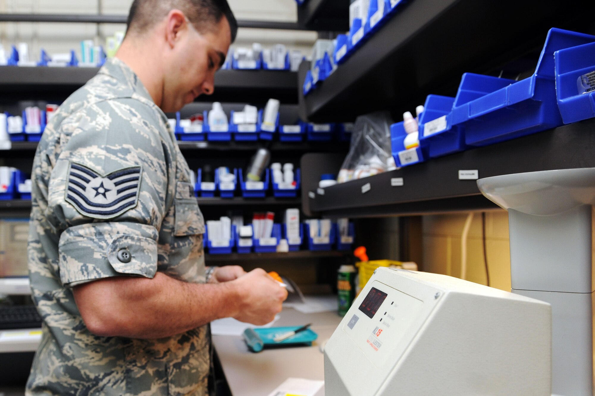KUNSAN AIR BASE, Republic of Korea -- Tech. Sgt. Paul Barnett, 8th Medical Support Squadron diagnostic therapeutic flight chief, attaches a label to a bottle of prescribed medication here May 24.Sergeant Barnett came from Keesler Air Force Base, Miss., and is a native of Jacksonville, N.C. (U.S. Air Force photo/Senior Airman Brittany Y. Bateman)