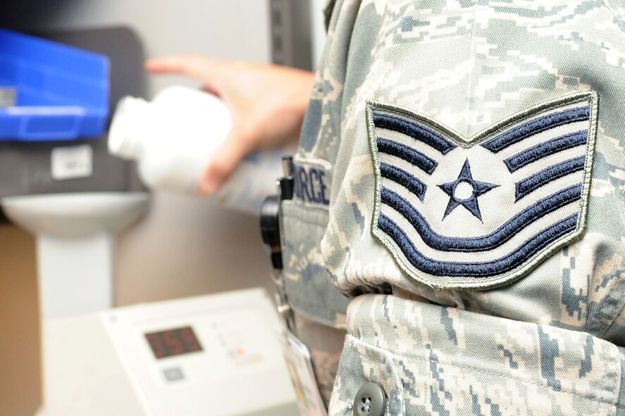 KUNSAN AIR BASE, Republic of Korea -- Tech. Sgt. Paul Barnett, 8th Medical Support Squadron diagnostic therapeutic flight chief, weighs medication before filling a prescription here May 24. The 8th MDSS fills approximately 1,100 prescriptions per month. (U.S. Air Force photo/Senior Airman Brittany Y. Bateman) 
