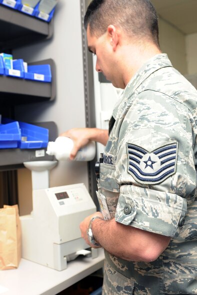 KUNSAN AIR BASE, Republic of Korea -- Tech. Sgt. Paul Barnett, 8th Medical Support Squadron diagnostic therapeutic flight chief, weighs medication before filling a prescription here May 24. The 8th MDSS fills approximately 1,100 prescriptions per month. (U.S. Air Force photo/Senior Airman Brittany Y. Bateman) 