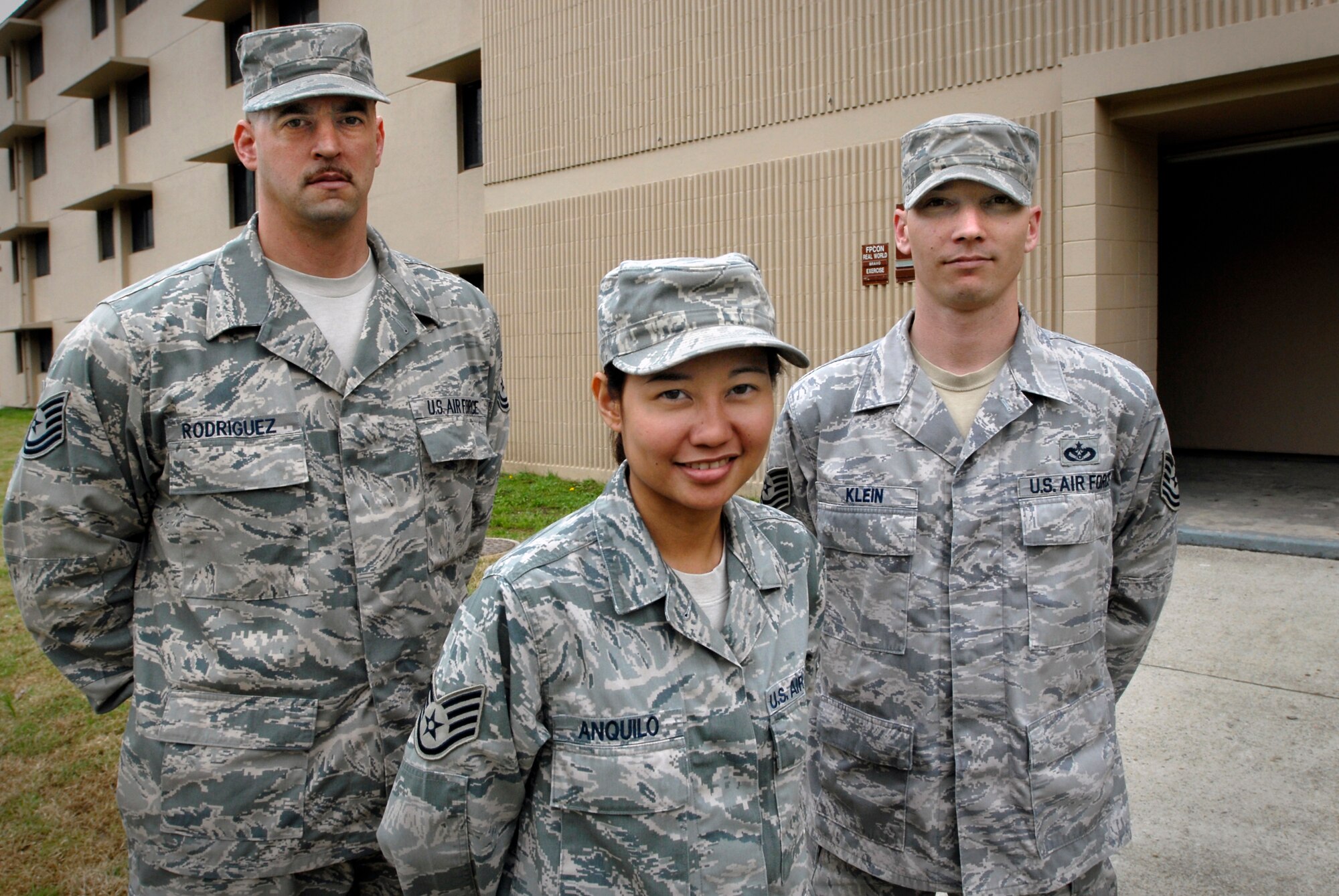 Dormitory management team members Tech. Sgt. Stephen Rodriguez, Staff Sgt. Shalah Anquilo, and Tech. Sgt. Justin Klein, all assigned to the 51st Civil Engineer Squadron, Osan Air Base, Republic of Korea, pose in front of newly renovated Building 717. The three Airmen are instrumental in ensuring the quality of life for Osan’s dormitory residents. (U.S. Air Force photo)
