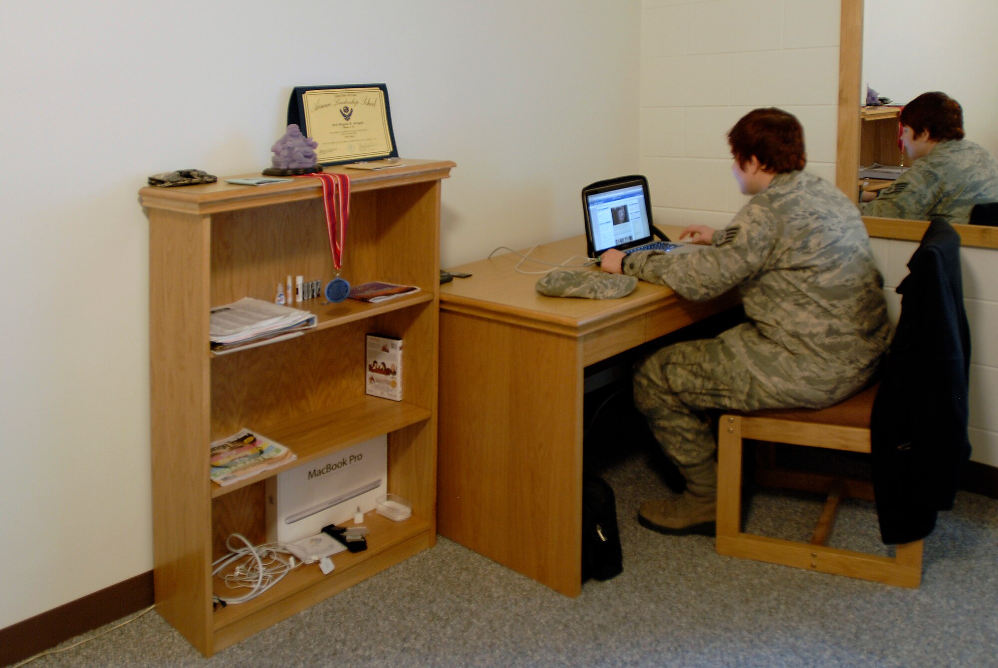 Staff Sgt. Megan Knight, an Airman dorm leader assigned to the 51st Civil Engineer Squadron, Osan Air Base, Republic of Korea, is surrounded by new furniture in here freshly painted and carpeted dormitory room in building 717. New furniture, fresh paint, and new wall and floor coverings were included in the recently completed renovations to buildings 717 and 718. (U.S. Air Force photo)