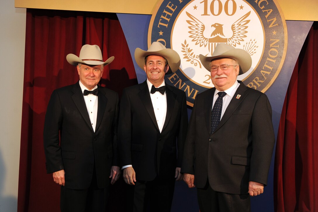 From left to right, Defense Secretary Robert M. Gates, British Defense Secretary Liam Fox, and former Polish President Lech Walesa pose for a photo wearing Stetson hats in honor of former President Ronald Reagan during the Ronald Reagan Centennial Gala in Washington, D.C., May 24, 2011. The hats were presented to them by the Ronald Reagan Presidential Foundation in remembrance of Reagan, who often wore Stetsons and cowboy boots.