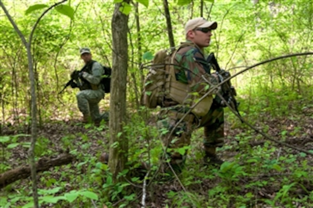 Army soldiers conduct a foot patrol while training at Camp Atterbury Joint Maneuver Training Center, Ind., on May 12, 2011.  The soldiers, assigned to the 2nd Battalion, 19th Special Forces Group, participated in a weeklong training exercise.  