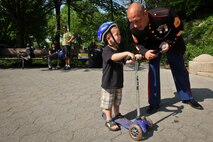 Reed Hershey, 2, from New York City, asks Gunnery Sgt. Jayme D. Dalberg, the small ensemble leader, a question about the Parris Island Marine Band as they perform  in the Central Park Band Shell, New York City, May 25. More than 3000 Marines, sailors and Coast Guardsmen will participate in community events and military demonstrations throughout the city. Fleet Week 2011 begins May 25 and continues through June 1.