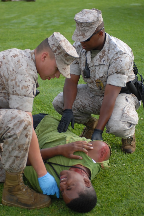 Military police at Marine Corps Recruit Depot San Diego, assist simulated casualties during Aztec Fury. This is a annual emergency response and crisis managment exercise.