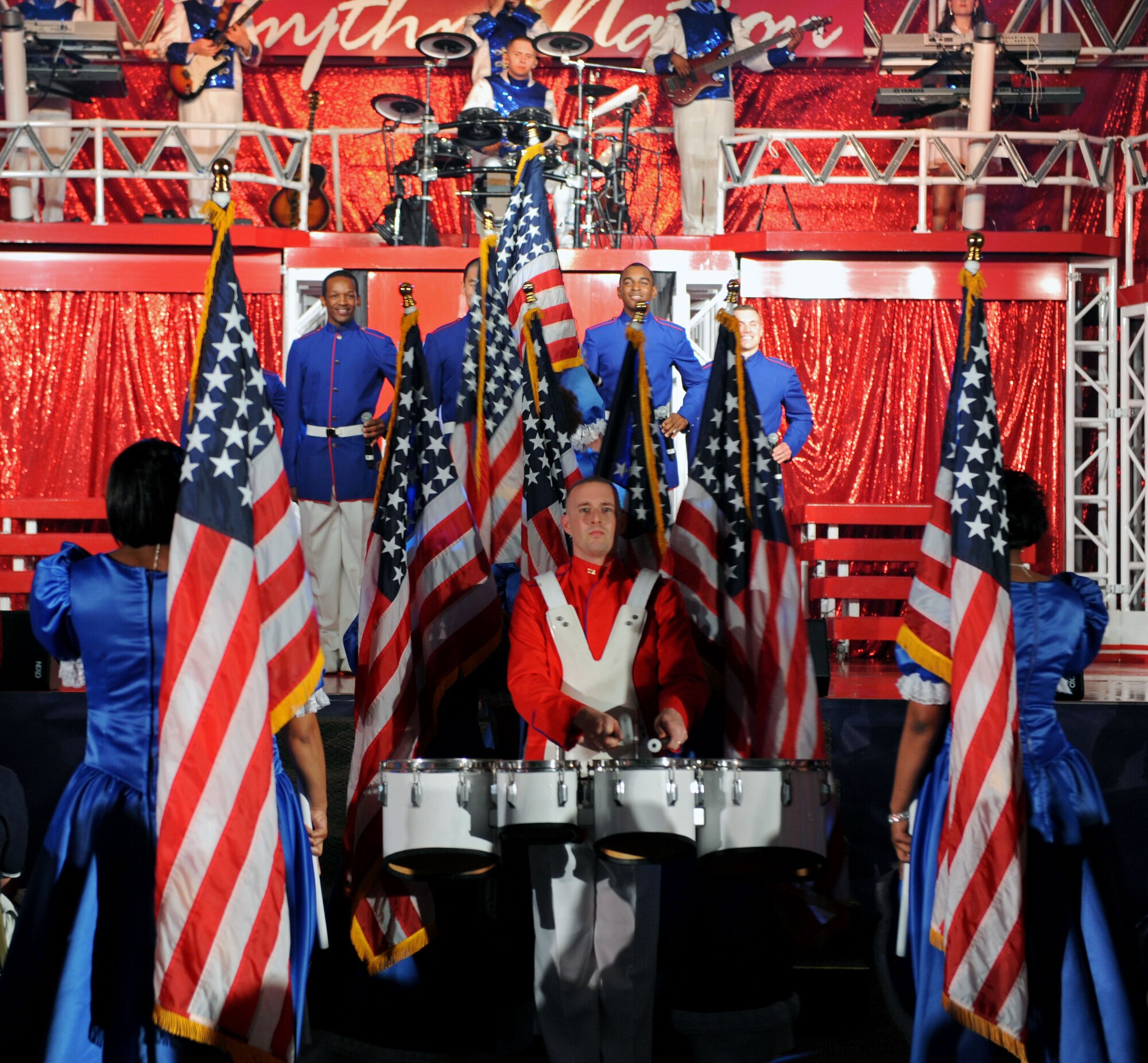 Members of Tops in Blue march to the stage during their 2011 tour 'Rhythm Nation' held at Hoban Hall on Barksdale Air Force Base, La., May 25. More than 400 people attended the show. Tops in Blue is known as the Air Force's expeditionary entertainers. The show featured the swingin' jazz, of Nat King Cole and Billie Holiday, the great rock n' roll sounds of Little Richard and Jerry Lee Lewis, the cool Motown R&B of Marvin Gaye and Tammi Terrell, hits by J-Lo and Lady Antebellum, some inspirational country sounds and much more. (U.S. Air Force Photo/Senior Airman La'Shanette V. Garrett) (RELEASED)