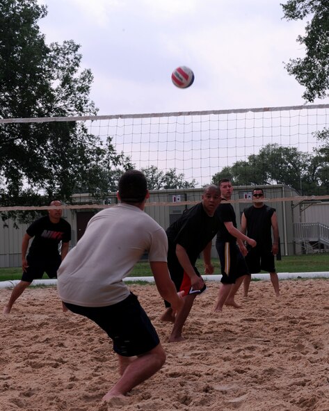 Airmen from the 2nd Operations Group and the 2nd Communications Squadron battle it out in a game of sandlot volleyball during Sports Day on Barksdale Air Force Base, La., May 25. Sports Day was designed to improve teamwork and promote the Air Force's Fit-to-Fight mission. (U.S. Air Force Photo/Senior Airman La'Shanette V. Garrett) (RELEASED) 