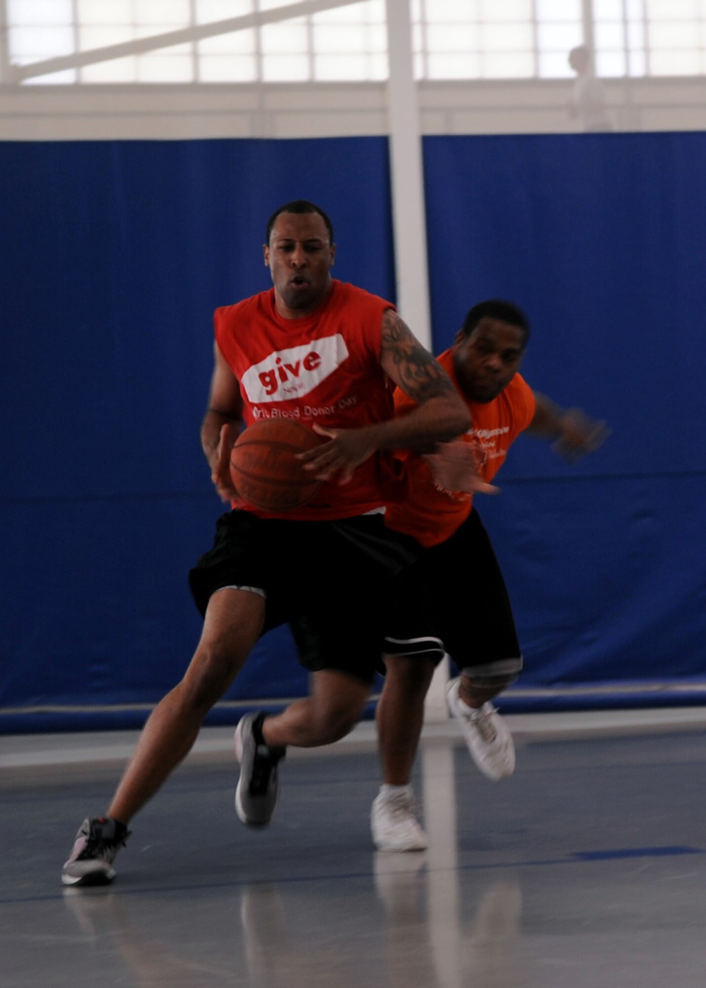 An Airman from the 608th Air Operations Center defends the basketball from an Airman of the 2nd Communications Squadron, during Sports Day at the fitness center on Barksdale Air Force Base, La., May 25. Each game had a 10-minute time limit and the first team to reach 15 won. (U.S. Air Force Photo/Senior Airman La'Shanette V. Garrett) (RELEASED) 