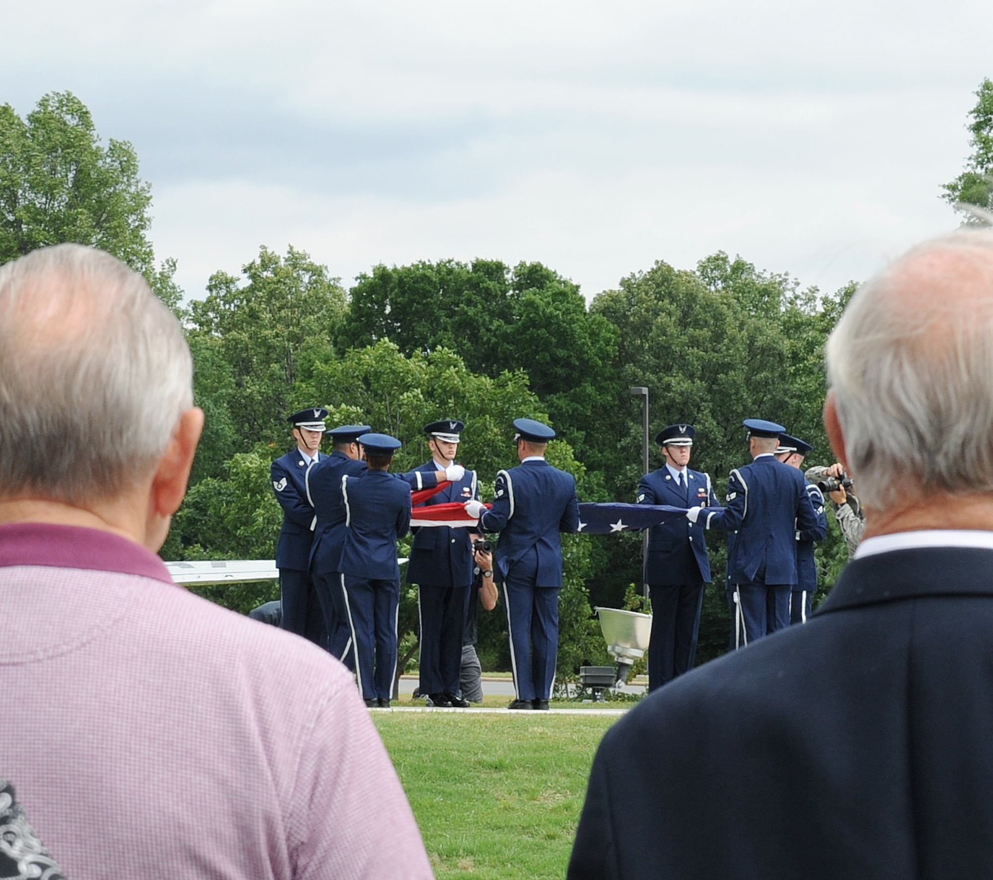 Retirees watch as base honor guard members fold the American flag during a Memorial Day retreat ceremony May 26, 2011, on Little Rock Air Force Base, Ark. The ceremony was a chance for Airmen and community members to honor the servicemembers who have fallen through the years.  (U.S. Air Force photo/Airman 1st Class Ellora Stewart)