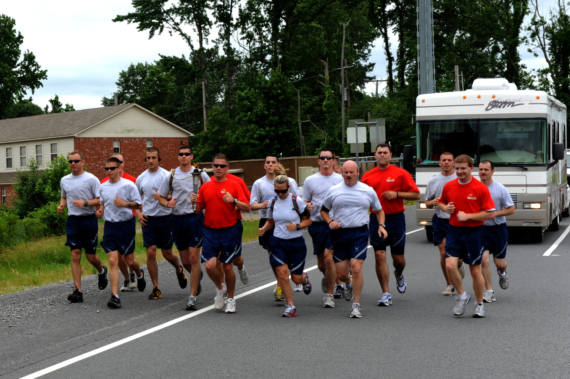 Members of the 19th Security Forces Squadron carry the Arkansas Special Olympics flame May 26. The Airmen carried the flame for six miles of its journey across the state. The state's Special Olympics opening ceremonies start May 26 and competitions run through May 28. (U.S. Air Force photo/Airman 1st Class Rusty Frank)