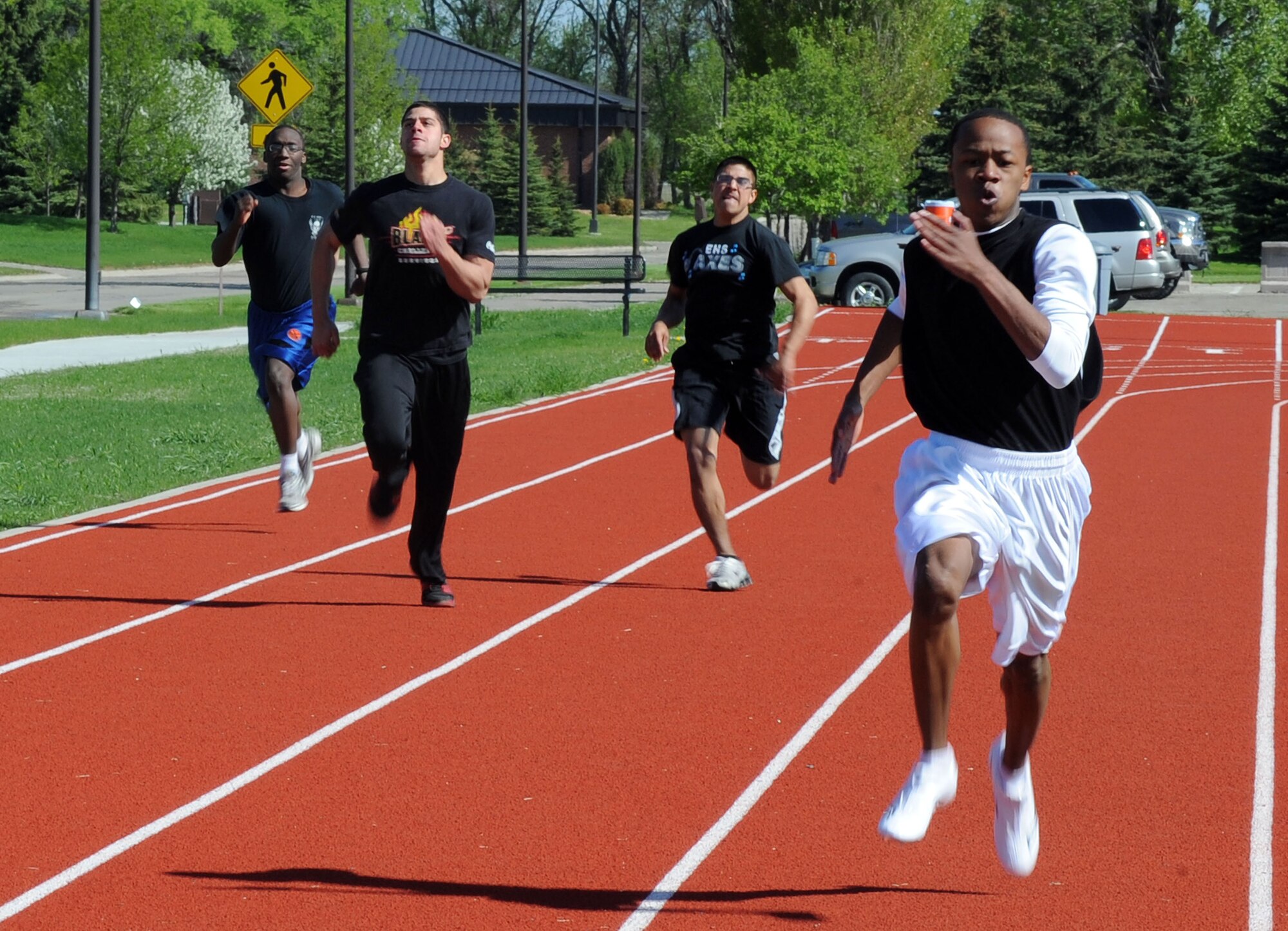 Members of the 319th Air Base Wing compete in the 200 meter sprint May 25 during the base’s annual Spring Fest competitions. The day included various events to boost the morale of servicemembers and their families. (U.S. Air Force photo by Senior Airman Amber Bennett)