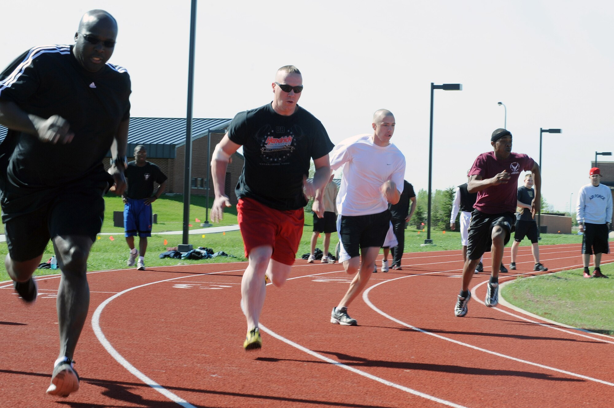 Members of the 319th Air Base Wing compete in the 200 meter race May 25 during the base’s annual Spring Fest competitions. The day included various events to boost the morale of servicemembers and their families. (U.S. Air Force photo by Senior Airman Amber Bennett)