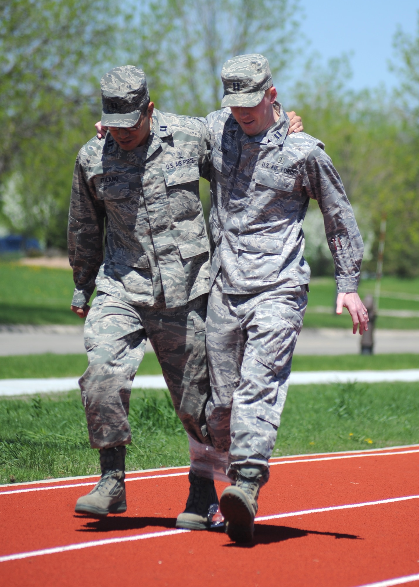 Capt. Justin Lusk and Capt. Ulises Atilano, both from the 319th Medical Group, work together to stay balanced during the three-legged race May 25 during the base’s annual Spring Fest competitions. (U.S. Air Force photo by Staff Sgt. Suellyn Nuckolls)