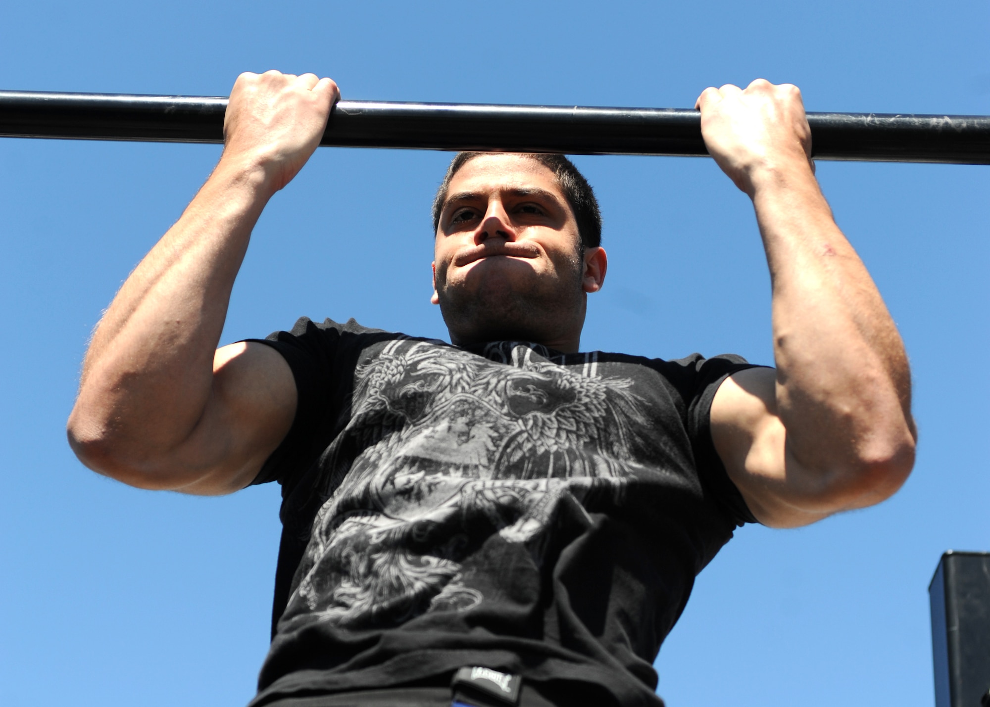 Airman 1st Class Adrian Rodriguez, 319th Civil Engineering Squadron, competes in the pull-up competition May 25 during the base’s annual Spring Fest competitions. (U.S. Air Force photo by Staff Sgt. Suellyn Nuckolls)