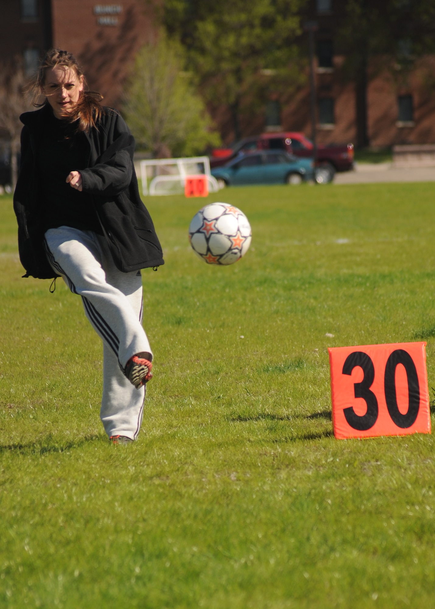 Senior Airman Stephanie List, 319th Civil Engineering Squadron, kicks a soccer ball during the Soccer Kick competition May 25 during the base’s annual Spring Fest competitions. (U.S. Air Force photo by Staff Sgt. Suellyn Nuckolls)