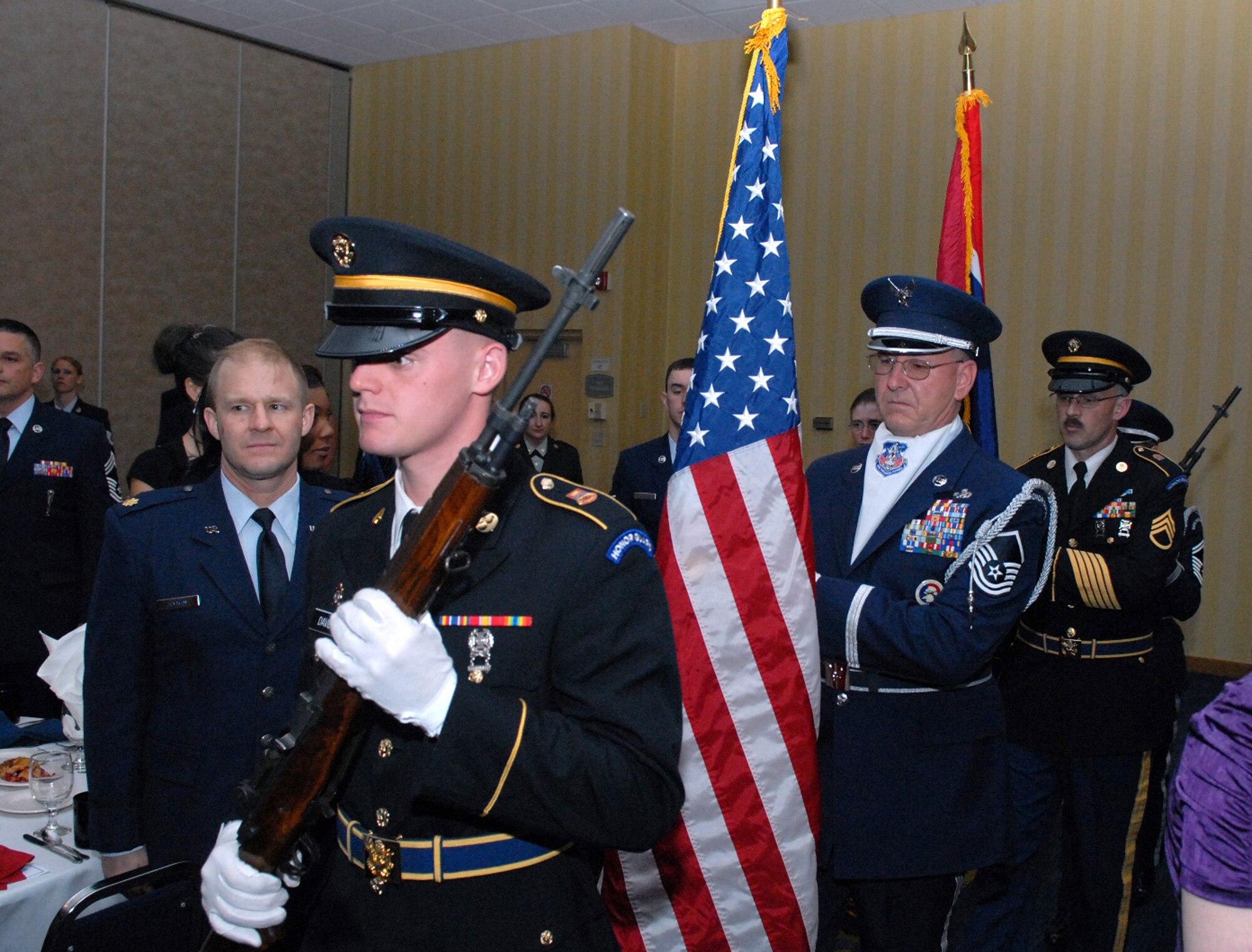 A multi-service honor guard posts the colors during the Armed Forces Day Banquet sponsored by the United States Air Force Association May 20. (U.S. Air Force photo by R.J. Oriez)
