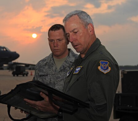 Maj. Gen. Floyd Carpenter, 8th Air Force commander, reviews the pre-flight check list with Staff Sgt.  Regis Reddinger, 2nd Maintenance Squadron, before his final B-52H Stratofortress flight on Barksdale Air Force Base, La., May 24. General Carpenter is retiring after 33 years of service and 3,000 flight hours in the B-52. (U.S. Air Force photo/Airman 1st Class Micaiah Anthony) (RELEASED)