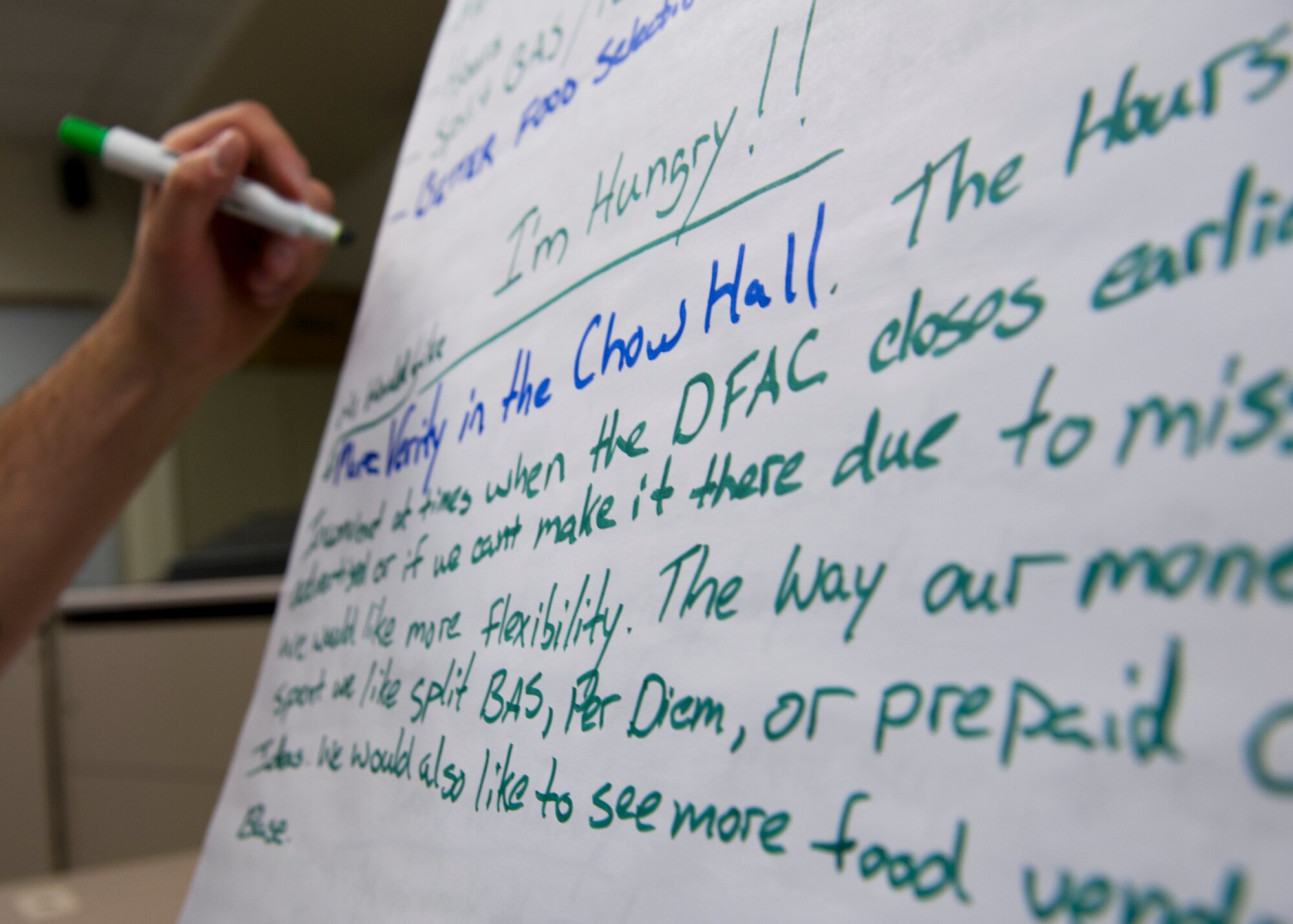 HOLLOMAN AIR FORC BASE, N.M. -- Staff Sgt. Aaron Burns, 7th Aircraft Maintenance Unit, writes down quality of life feedback, May, 24, 2011, during Holloman’s Caring for People Forum. The forum was held for Airmen, Department of Defense civilians and their families to discuss improvements to support services such as teen support, deployment support, family support, single Airmen support, special needs support, health and wellness, spouse communications and Reserve support. (U.S. Air Force photo by Senior Airman Veronica Stamps/Released)