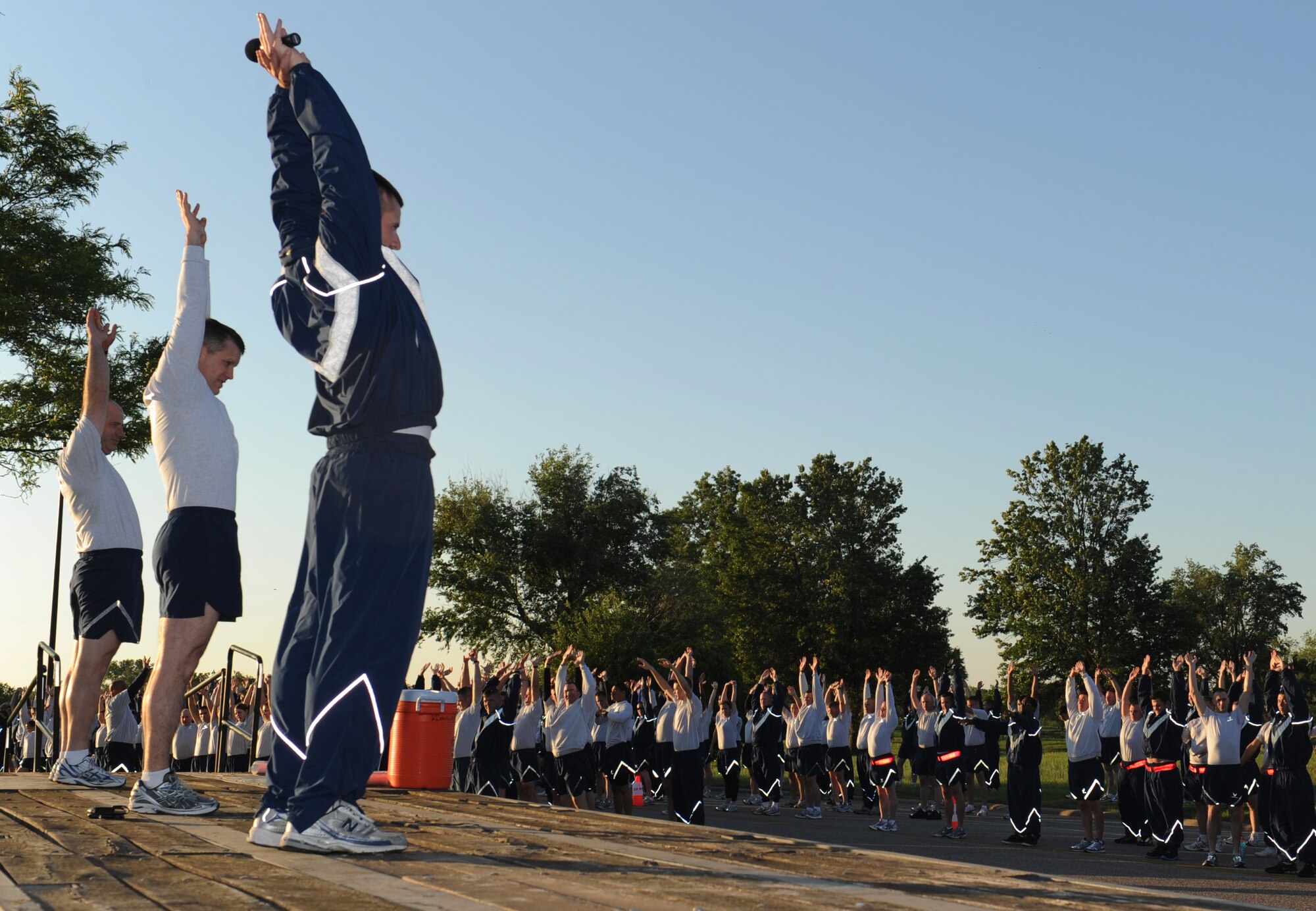Staff Sgt. Daniel Sperry, 22nd Air Refueling Wing ground safety technician, leads McConnell members in stretching before a wing formation run May 26, 2011, McConnell Air Force Base, Kan. The wing run kicks off McConnell’s 2011 Critical Days of Summer campaign, which began May 27, 2011. The goal of the campaign is to ensure that all of Team McConnell has an injury-free summer. (U.S. Air Force Photo/Airman 1st Class Katrina M. Brisbin)