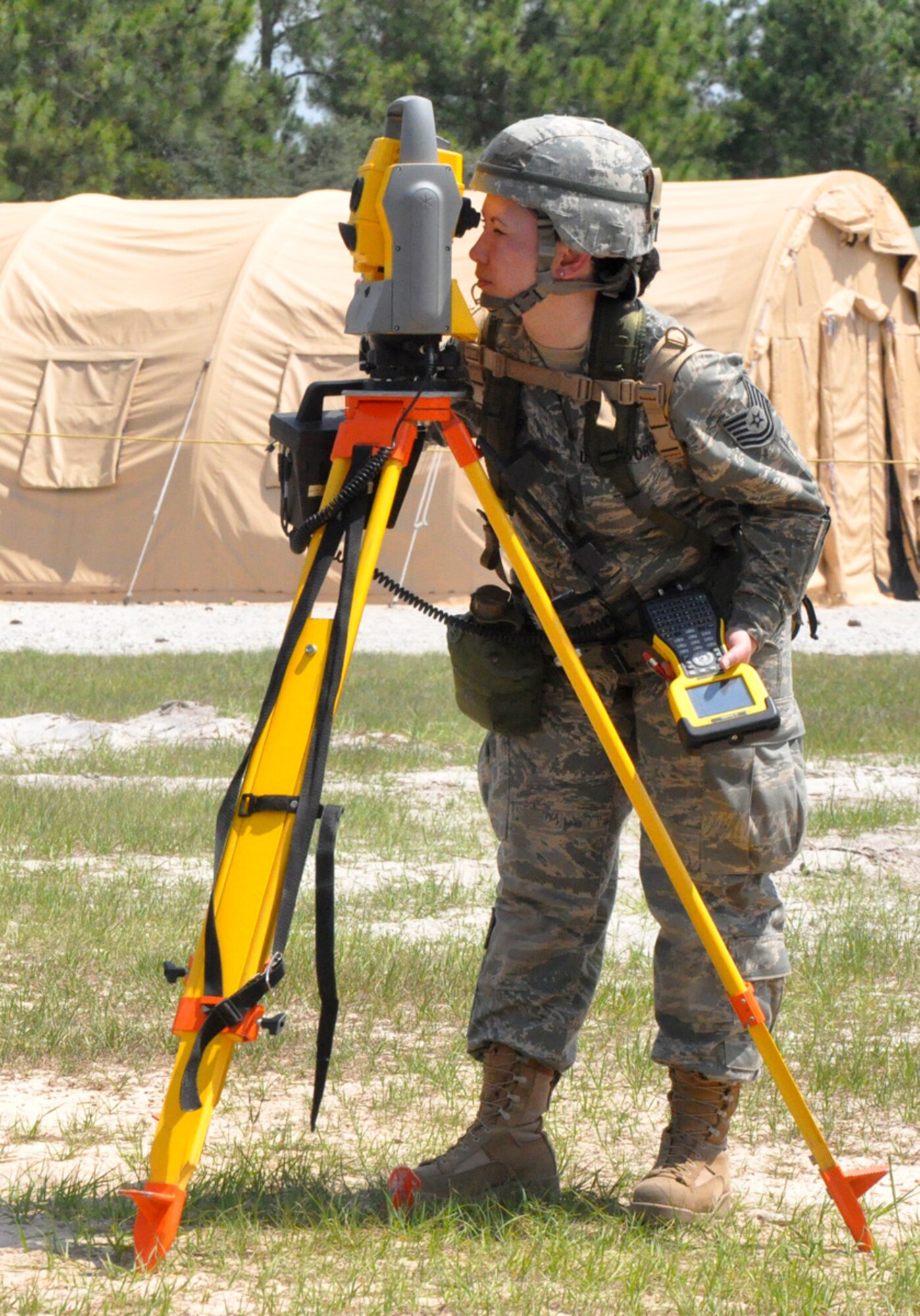 U.S. Air Force Tech Sgt. Jennifer Greer from the 446th Civil Engineer Squadron uses surveying equipment to calculate the height of a base water tower during a field exercise at Tyndall Air Force Base, Fla. on May 26, 2011. Sergeant Greer is one of 30 Reservists from the 446th CES participating in Silver Flag 2011, a week-long training exercise designed to improve the readiness capability of Air Force civil engineers. Sergeant Greer, of Puyallup, Wash., is an engineering craftsman with the 446th CES. (U.S. Air Force photo by Staff Sgt. Grant Saylor/Released)
