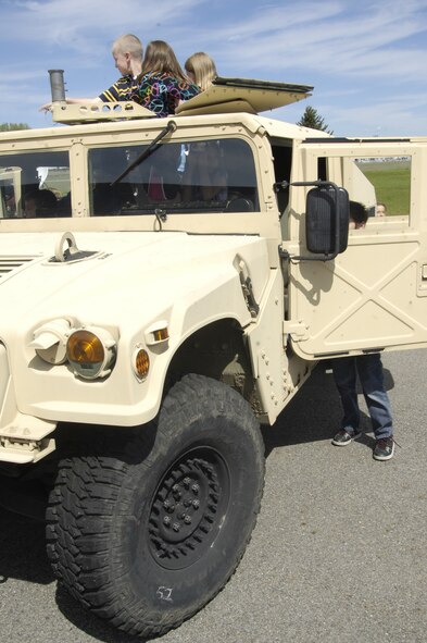 Students from Michael Anderson Elementary School, pile into a high mobility multipurpose wheeled vehicle to check out all of its gears and gadgets May 19, 2011 at the elementary school. (U.S. Air Force photo by Airman 1st Class Earlandez M. Young)