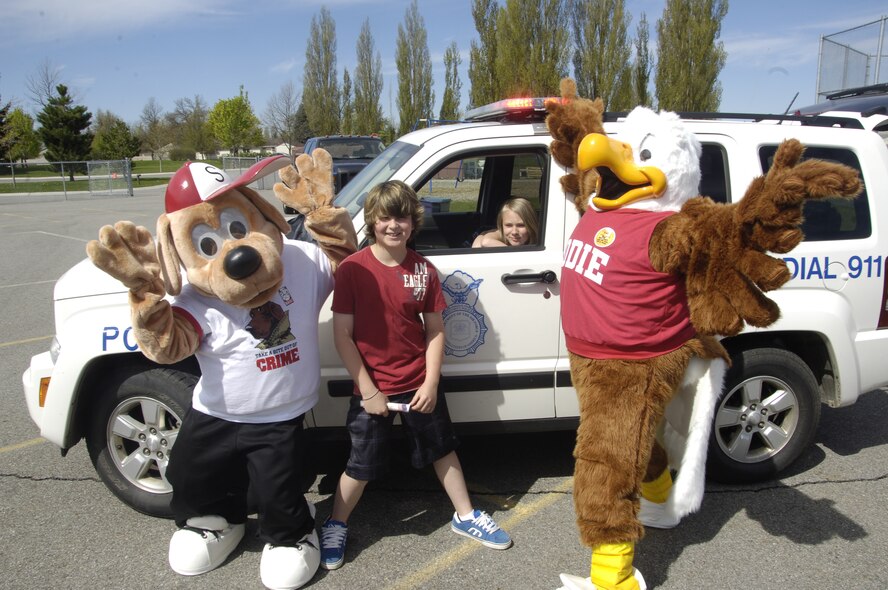 Eddie, the eagle, and Scrappy, the crime dog , joke around with kids May 19,2011 at Michael Anderson Elementary School here. McGruff, the crime dog, was also at the school to teach kids to just say no to drugs. (U.S. Air Force photo by Airman 1st Class Earlandez M. Young)