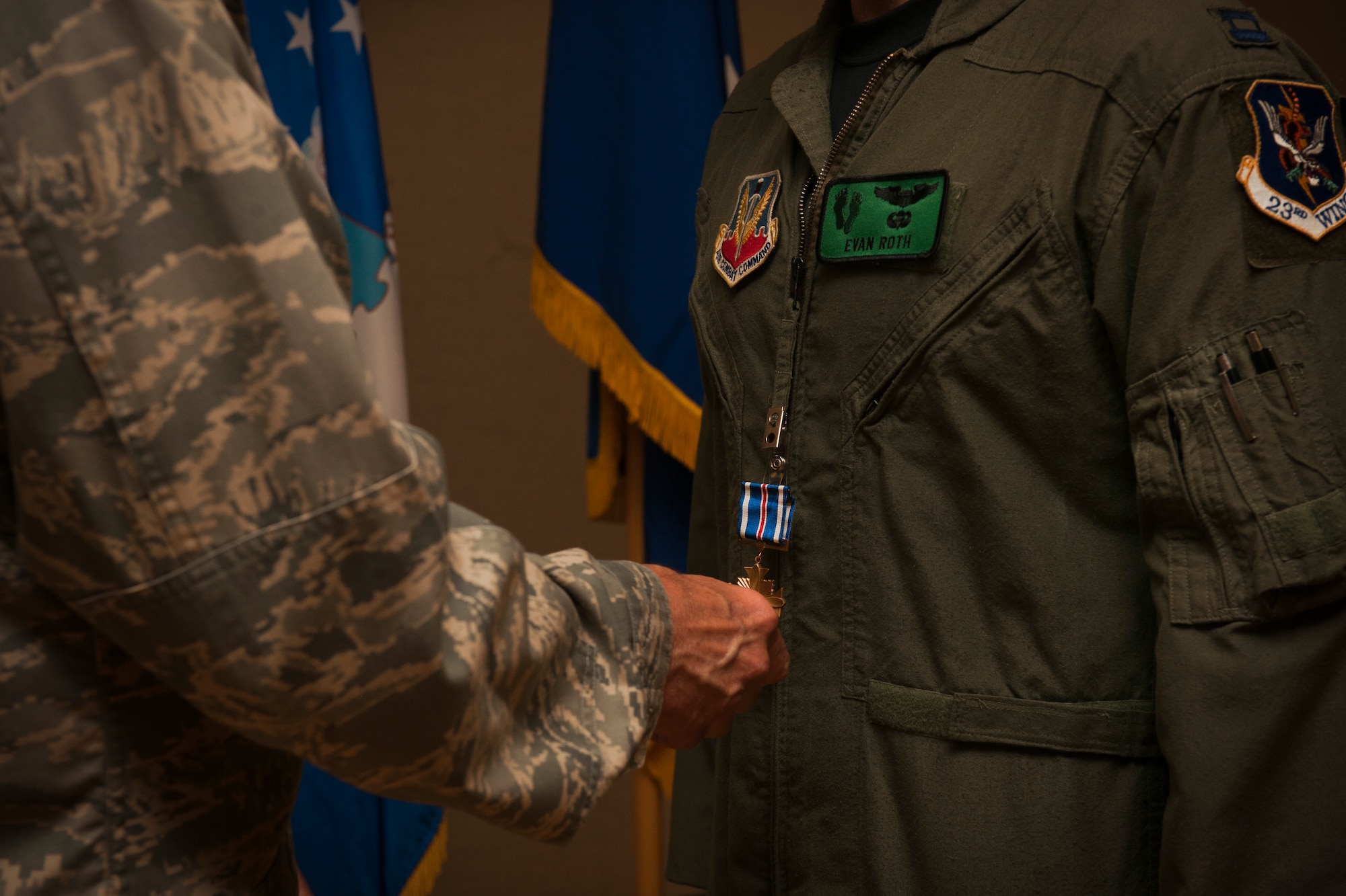 MOODY AIR FORCE BASE, Ga.-- Gen. William M. Fraser III, commander of Air Combat Command, places a Distinguished Flying Cross Medal on Capt. Evan Roth, 41st Rescue Squadron flight commander, during an award ceremony May 20. Captain Roth rescued a casualty and an injured soldier, flying them to the nearest medical facility and enabling the ground unit to complete their mission. (U.S. Air Force photo/Airman 1st Class Joshua Green)(RELEASED)
