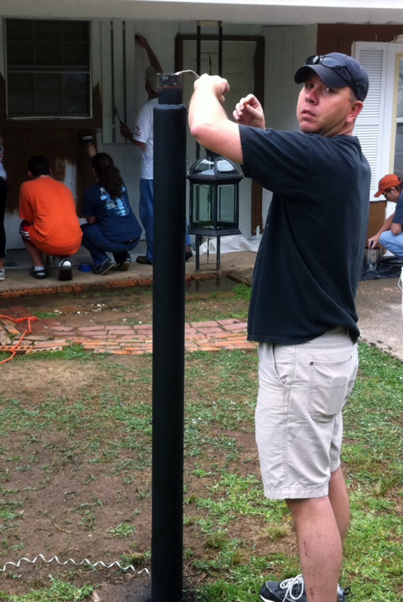 SHREVEPORT, La. - Master Sgt. Wesley Clark, Headquarters Eighth Air Force, fixes electrical lines in a lamp post during the “Paint Your Heart Out Shreveport” project May 21. Almost a dozen members of the Eighth Air Force A4/7 participated in the Paint Your Heart Out Shreveport project, which provided a facelift to more than 50 homes throughout the city. (U.S. Air Force photo by Master Sgt. Lee Meyers)