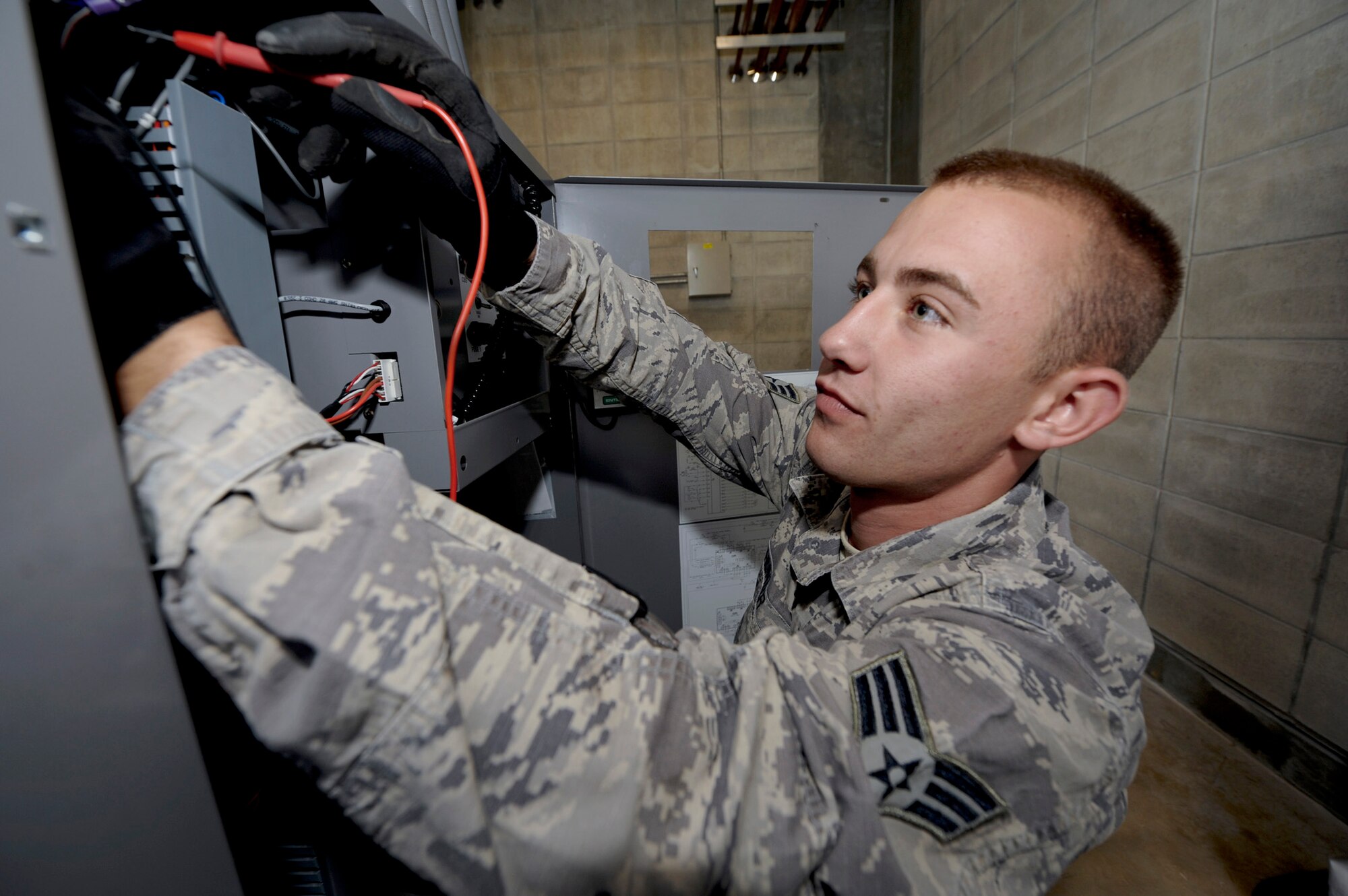 Senior Airman Derek Hunter checks electrical circuits on a heating ventilation and cooling system April 21, 2011, at Kadena Air Base, Japan. Base officials recently instituted an initiative through the Air Force Smart Operations for the 21st Century program to replace old, outdoor AC chillers with protected, indoor equipment to save the Air Force potentially millions of dollars in parts and energy. Airman Hunter is assigned an heating, ventilation, air conditioning and refrigeration technician assigned to the to the 18th Civil Engineer Squadron. (U.S. Air Force photo/Staff Sgt. Jonathan Steffen)