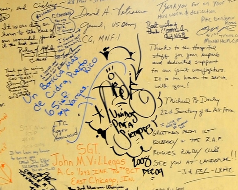 Service members left their marks on the walls of the contingency airlift staging facility at Joint Base Balad, Iraq. Since the troop surge in 2007, wounded warriors and top military officials have written messages as a way to commemorate their fallen comrades and to thank the JB Balad hospital staff. (U.S. Air Force photo/Staff Sgt. Keyonna Fennell)
