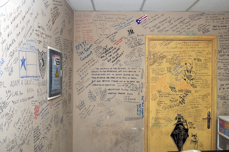 Service members left their marks on the walls of the contingency airlift staging facility at Joint Base Balad, Iraq. Since the troop surge in 2007, wounded warriors and top military officials have written messages as a way to commemorate their fallen comrades and to thank the JB Balad hospital staff. (U.S. Air Force photo/Staff Sgt. Keyonna Fennell)
