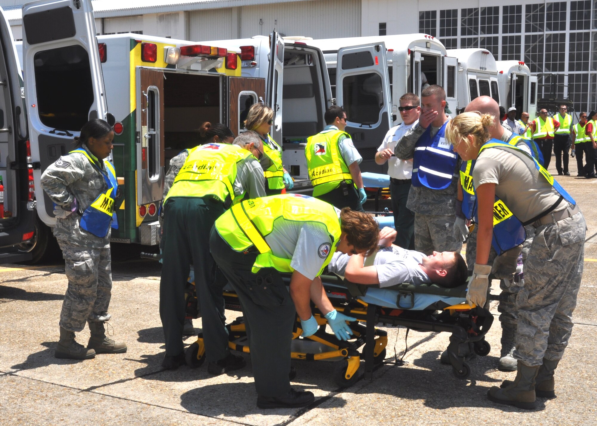 A team of 81st Medical Group Hospital medics and Acadian EMTs prepare to place a casualty in an ambulance for transport to a local hospital during the exercise.  (U.S. Air Force photo by Steve Pivnick)