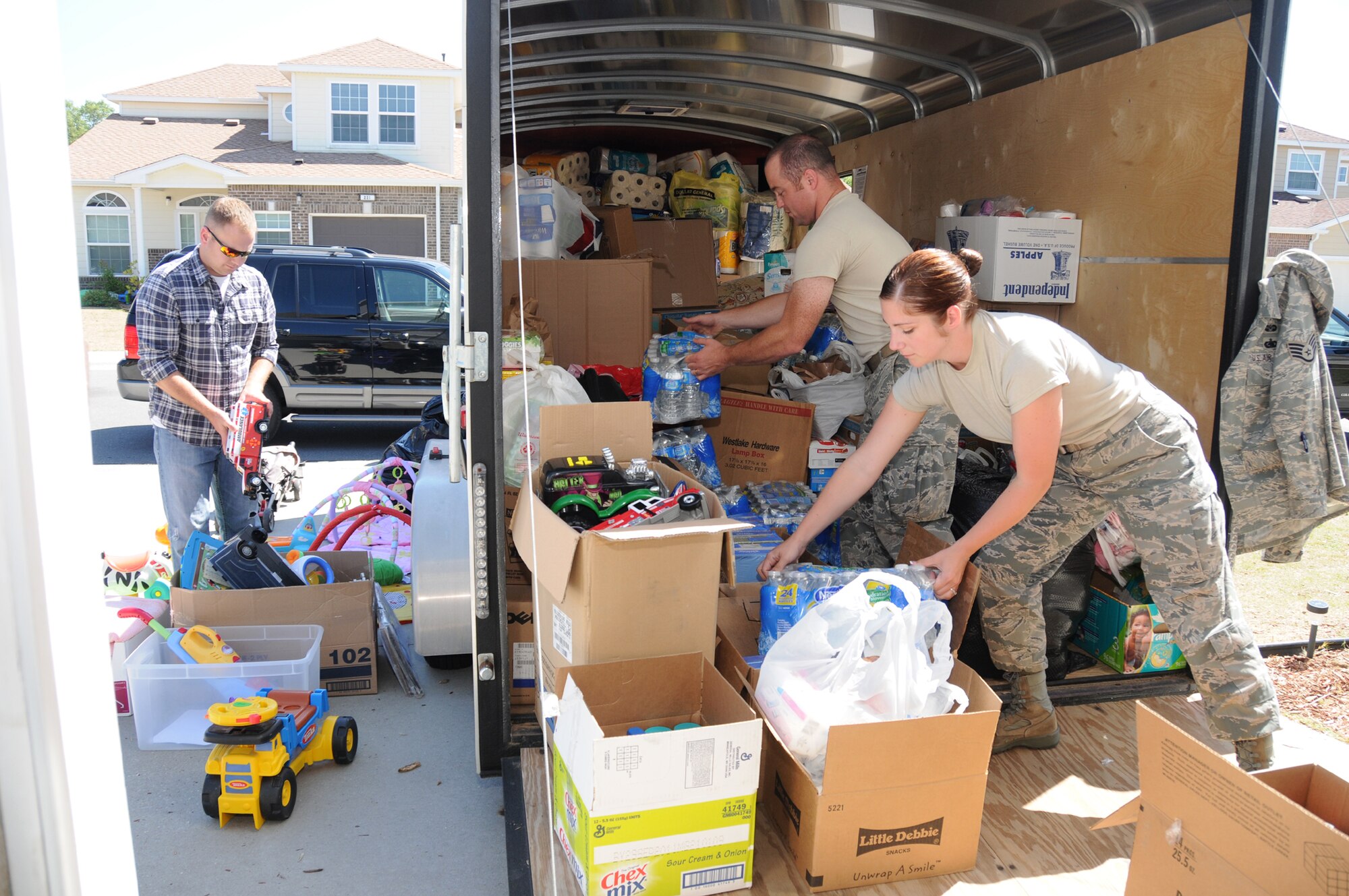 From left, Staff Sgts. Creighton Cope, 334th Training Squadron; Brian Thornton, Area
Defense Counsel; and Brandy Defore, 81st TrainingWing, load a truck with donations for tornado victims in Tuscaloosa, Ala., May 17. The base community provided 9,000 pounds of supplies with an estimated value of $20,000, according to Sergeant Defore.  (U.S. Air Force photo by Kemberly Groue)