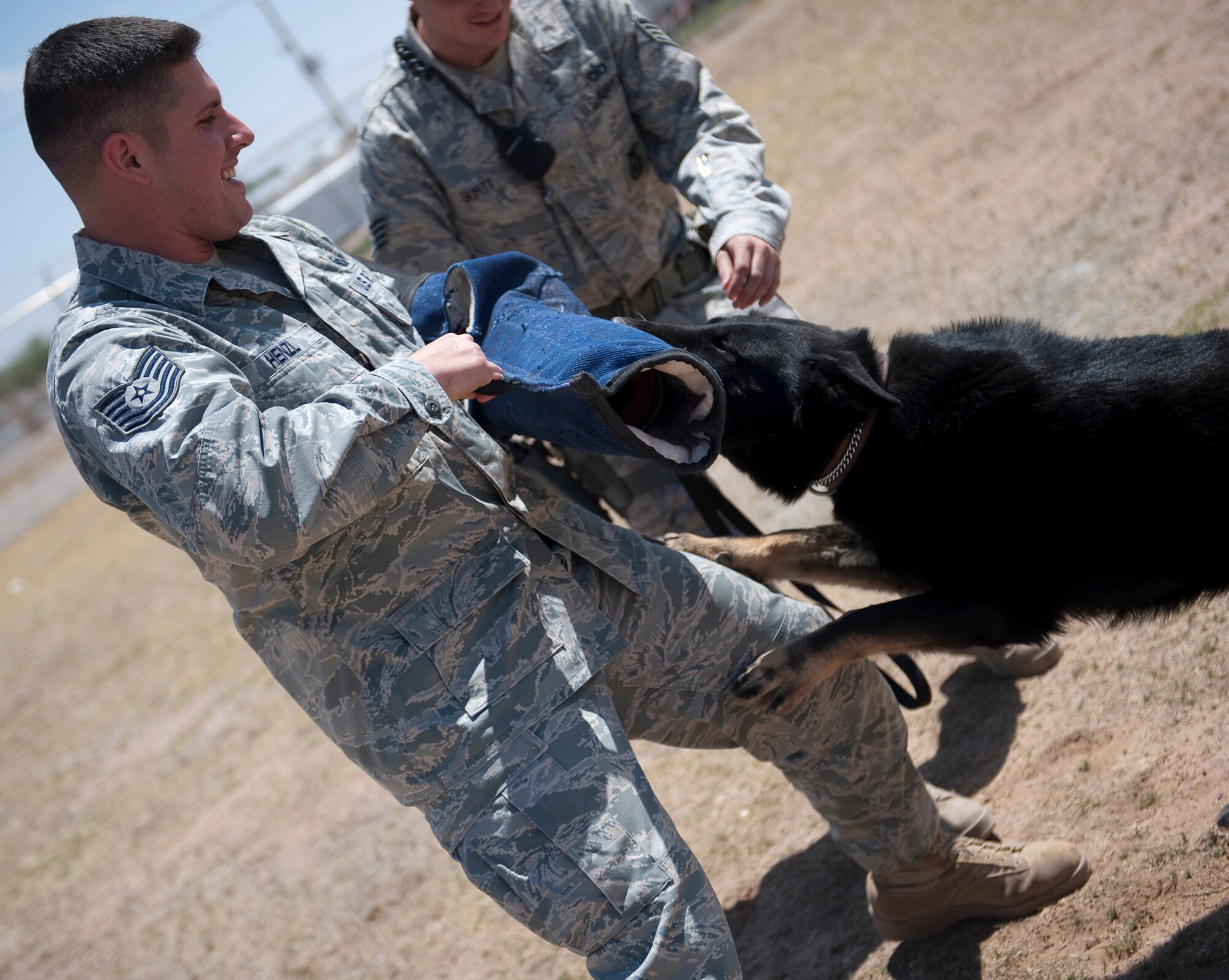 HOLLOMAN AIR FORCE BASE, N.M. -- Tech. Sgt. Thomas Henzl, 49th Security Forces Squadron kennel master, trains with military working dog Roki M628, May 5, 2011, at the obstacle course. Airmen from the MWD section train with their assigned canine in a realistic but fun way while also using techniques to avoid injury to the canines. (U.S. Air Force by Senior Airman Veronica Stamps/Released)