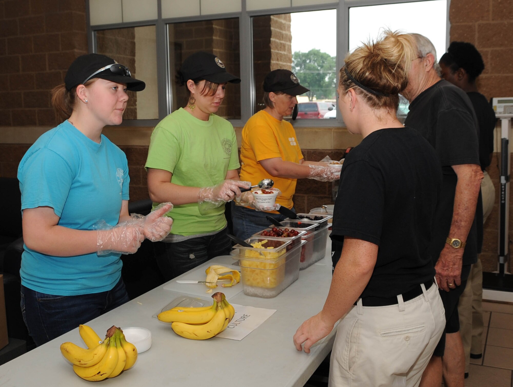 Emily Dahlberg (left), Katie Hardage and Mary Dahlberg,from a local yogurt shop, present frozen yogurt to participants during the 2nd Bomb Wing Sports Day on Barksdale Air Force Base, La., May 24. Sports Day is comprised of various competitive athletic events to help promote physical fitness and information booths concerning health and wellness. (U.S. Air Force photo/Senior Airman Kristin High)(RELEASED) 