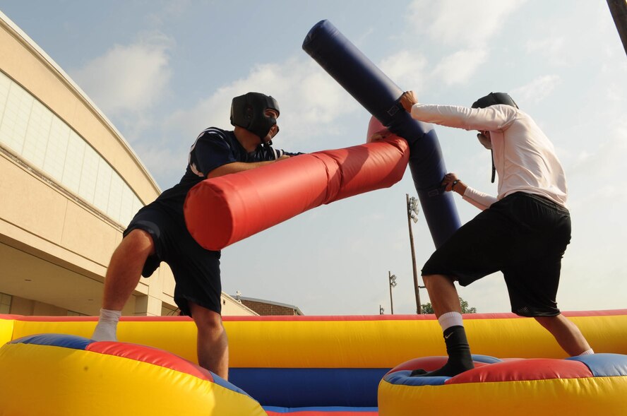 Staff Sgt. Keith Carpenter and Airman Joseph Palacios, 2nd Munitions Squadron, joust in an inflatable battle dome during the 2nd Bomb Wing Sports Day on Barksdale Air Force Base, La., May 24. Sports Day is comprised of various competitive athletic events to help promote physical fitness and information booths concerning health and wellness.(U.S. Air Force photo/Senior Airman Kristin High)(RELEASED) 