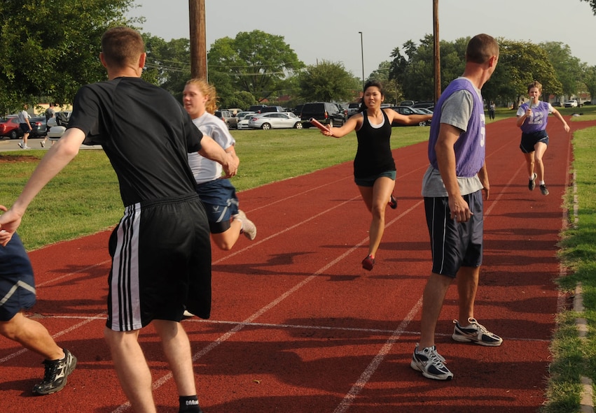 Airmen participate in a 'Superman' relay race during the 2nd Bomb Wing Sports Day on Barksdale Air Force Base, La., May 24. Sports Day is comprised of various competitive athletic events to help promote physical fitness and information booths concerning health and wellness. (U.S. Air Force photo/Senior Airman Kristin High)(RELEASED) 