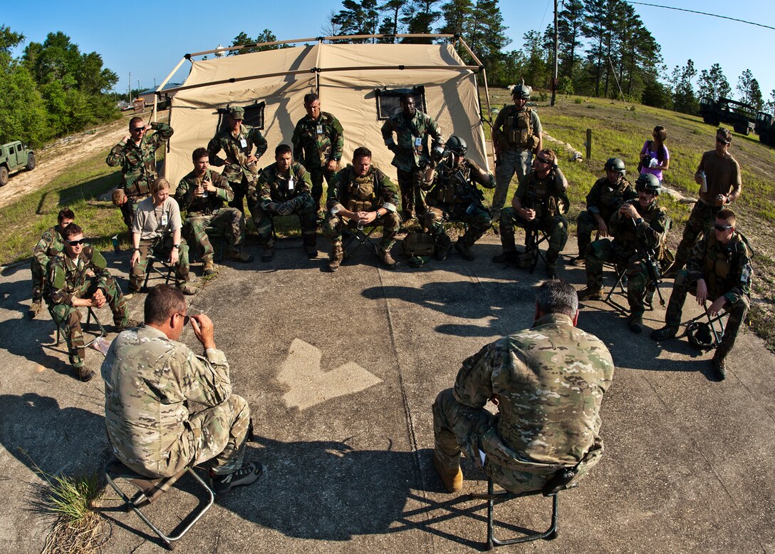 Combat Aviation Advisor students are debriefed by 371st Special Operations Training Squadron instructors after a scenario during the Raven Claw exercise May 24 at Duke Field, Fla.  As part of the exercise, 19 CAA students deploy to a foreign nation to advise and train their air forces in fixed wing and rotary aircraft operations.  The four-day exercise is the capstone of 12 weeks of baseline certification training for CAA.  The year-long process to become a CAA also includes months of language and flight training.  (U.S. Air Force photo/Tech. Sgt. Samuel King Jr.)