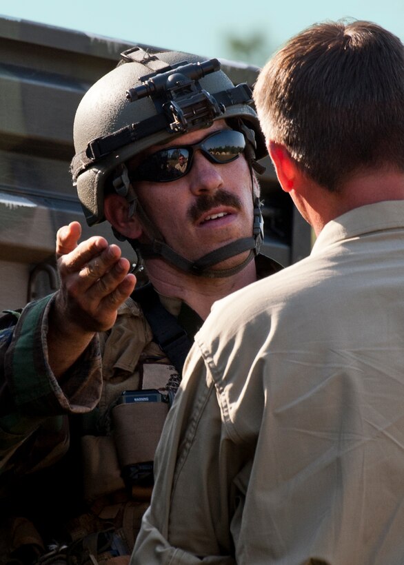 Capt. Robert Rennell, team intelligence officer, discusses an incident with a “simulated” partner-nation officer during the Combat Aviation Advisor course’s Raven Claw exercise May 24 at Duke Field, Fla.  As part of the exercise, 19 CAA students deployed to a foreign nation to advise and train their air forces in fixed wing and rotary aircraft operations.  The four-day exercise is the capstone of 12 weeks of baseline certification training for CAA.  The year-long process to become a CAA also includes months of language and flight training.  (U.S. Air Force photo/Tech. Sgt. Samuel King Jr.)