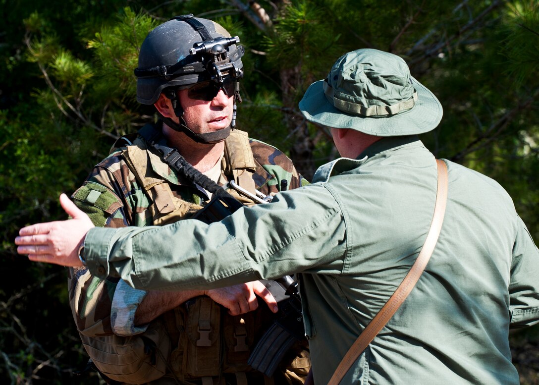 Lt. Col. Rodrigo Vial, 5th Special Operations Squadron, talks with a “simulated” partner-nation special forces soldier during the Combat Aviation Advisor course’s Raven Claw exercise May 24 at Duke Field, Fla.  Colonel Vial and four other 5th SOS Airmen completed the course and earned their air commando badges.  They were the first reservists to ever take the course, which prepares Airmen to deploy to partner nations to train personnel to engage in air operations. (U.S. Air Force photo/Tech. Sgt. Samuel King Jr.)