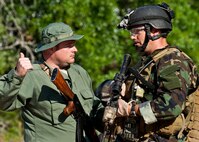Maj. Michael Black, 5th Special Operations Squadron, talks with a “simulated” partner-nation special forces soldier during the Combat Aviation Advisor course’s Raven Claw exercise May 24 at Duke Field, Fla.  Major Black and four other 5th SOS Airmen completed the course and earned their air commando badges.  They were the first reservists to ever take the course, which prepares Airmen to deploy to partner nations to train personnel to engage in air operations. (U.S. Air Force photo/Tech. Sgt. Samuel King Jr.)