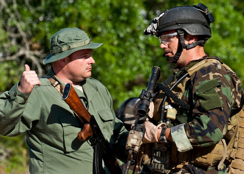 Maj. Michael Black, 5th Special Operations Squadron, talks with a “simulated” partner-nation special forces soldier during the Combat Aviation Advisor course’s Raven Claw exercise May 24 at Duke Field, Fla.  Major Black and four other 5th SOS Airmen completed the course and earned their air commando badges.  They were the first reservists to ever take the course, which prepares Airmen to deploy to partner nations to train personnel to engage in air operations. (U.S. Air Force photo/Tech. Sgt. Samuel King Jr.)