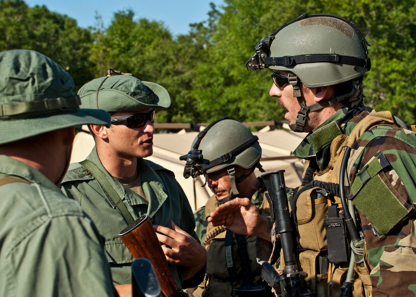 Capt. Robert Rennell, team intelligence officer, discusses an incident with “simulated” partner-nation special forces soldiers during the Combat Aviation Advisor course’s Raven Claw exercise May 24 at Duke Field, Fla.  As part of the exercise, 19 CAA students deployed to a foreign nation to advise and train their air forces in fixed wing and rotary aircraft operations.  The four-day exercise is the capstone of 12 weeks of baseline certification training for CAA.  The year-long process to become a CAA also includes months of language and flight training.  (U.S. Air Force photo/Tech. Sgt. Samuel King Jr.)