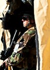 Tech. Sgt. William Strange, team sergeant, scans the area from the mission control tent during the Combat Aviation Advisor course’s Raven Claw exercise May 24 at Duke Field, Fla.  As part of the exercise, 19 CAA students deployed to a foreign nation to advise and train their air forces in fixed wing and rotary aircraft operations.  The four-day exercise is the capstone of 12 weeks of baseline certification training for CAA.  The year-long process to become a CAA also includes months of language and flight training.  (U.S. Air Force photo/Tech. Sgt. Samuel King Jr.)