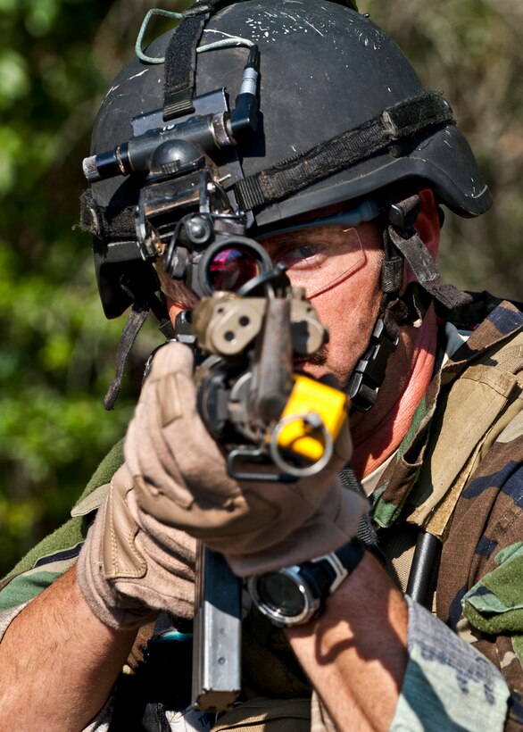Maj. Michael Black, 5th Special Operations Squadron, aims his weapon downrange after his team heard sounds of a firefight west of their camp during the Combat Aviation Advisor course’s Raven Claw exercise May 24 at Duke Field, Fla.  Major Black and four other 5th SOS Airmen completed the course and earned their air commando badges.  They were the first reservists to ever take the course, which prepares Airmen to deploy to partner nations to train personnel to engage in air operations. (U.S. Air Force photo/Tech. Sgt. Samuel King Jr.)