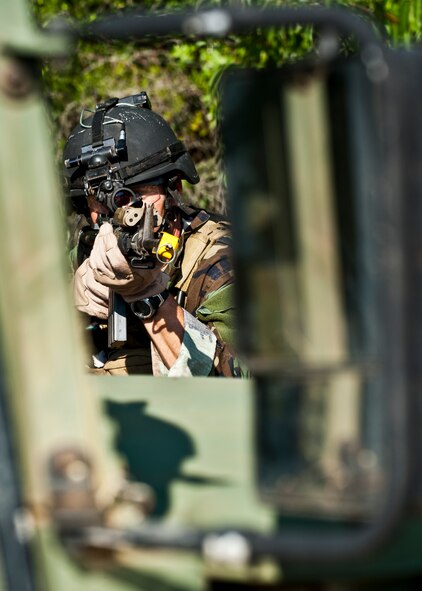 Maj. Michael Black, 5th Special Operations Squadron, aims his weapon downrange after his team heard sounds of a firefight west of their camp during the Combat Aviation Advisor course’s Raven Claw exercise May 24 at Duke Field, Fla.  Major Black and four other 5th SOS Airmen completed the course and earned their air commando badges.  They were the first reservists to ever take the course, which prepares Airmen to deploy to partner nations to train personnel to engage in air operations. (U.S. Air Force photo/Tech. Sgt. Samuel King Jr.)