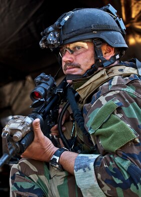 Maj. Michael Black, 5th Special Operations Squadron, guards the control center tent after his team heard sounds of a firefight west of their camp during the Combat Aviation Advisor course’s Raven Claw exercise May 24 at Duke Field, Fla.  Major Black and four other 5th SOS Airmen completed the course and earned their air commando badges.  They were the first reservists to ever take the course, which prepares Airmen to deploy to partner nations to train personnel to engage in air operations. (U.S. Air Force photo/Tech. Sgt. Samuel King Jr.)